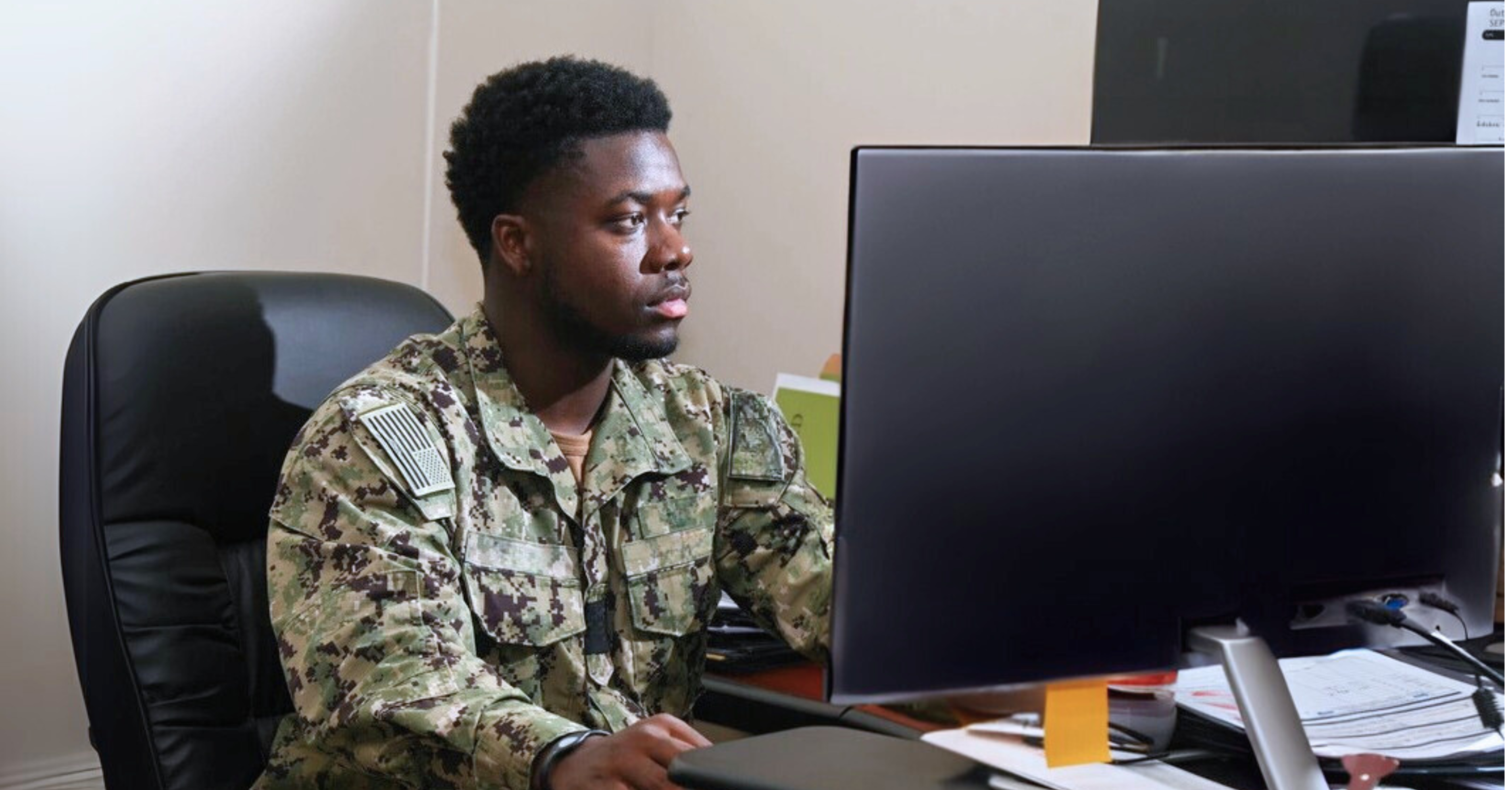 Navy service man working at a computer