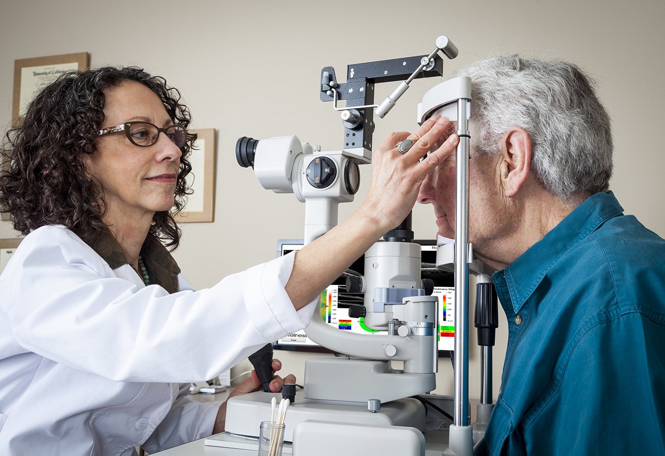 Image of a patient getting his eyes checked my a medical professional