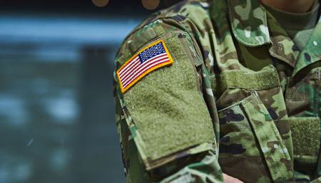 Military person arm displaying the American flag
